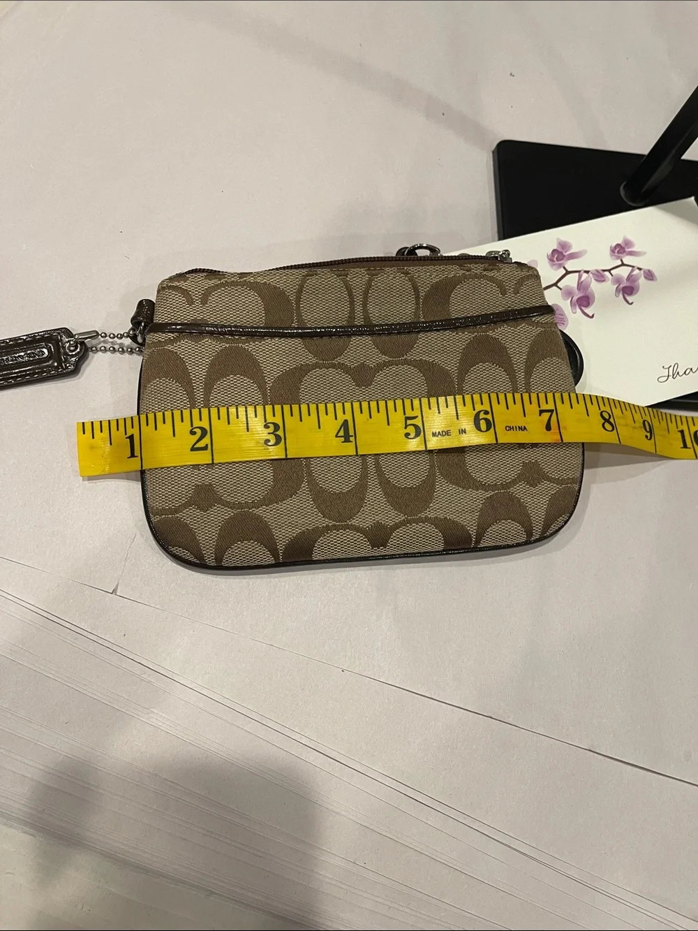 Coach Signature Small Wristlet in a khaki zipped coin purse